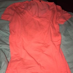 A bright orange v-neck tight shirt!